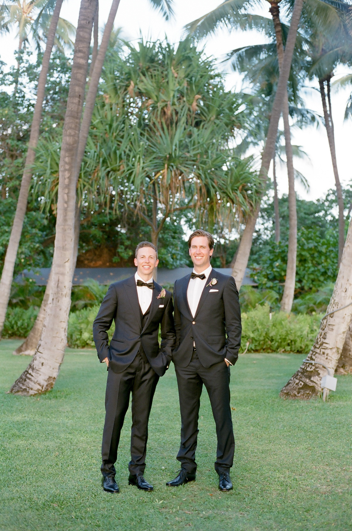 groom and best man black bow tie pose