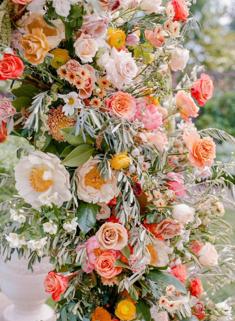 citrus inspired wedding flowers with peonies, roses, cosmos and ranunculus at lairmont manor