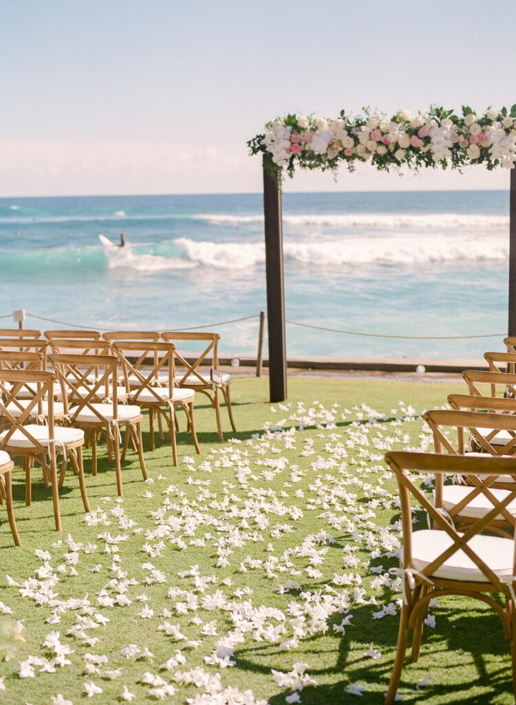 Surfers in the background at Corinne & Nathans Wedding in Kauai at The Beach House Restaurant