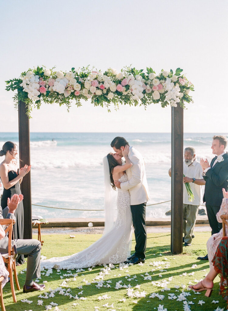 First Kiss at Corinne & Nathans Wedding in Kauai at The Beach House Restaurant